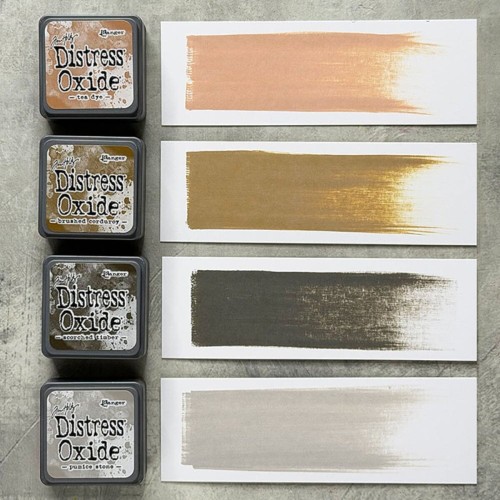 Cztery kolory tuszu Distress Mini Oxide z zestawu Kit 18: Tea Dye, Brushed Corduroy, Scorched Timber i Pumice Stone ułożone razem
